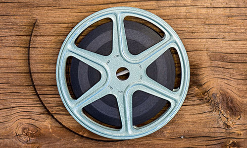 Old Movie Film Reel 16mm On The Wooden Table Stock Photo, Picture